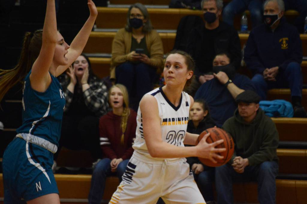 Lady Mariner Mel Morris tries to move around a Nikiski Bulldog during Senior Night on Friday, Feb. 25, 2022, at the Alice Witte Gym at Homer High School in Homer, Alaska. (Photo by Michael Armstrong/Homer News)
