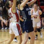 Soldotnas Kaitlyn McAnelly grabs a rebound in front of Kenai Centrals Emilee Wilson on Friday, Feb. 25, 2022, at Kenai Central High School in Kenai, Alaska. (Photo by Jeff Helminiak/Peninsula Clarion)