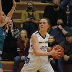 Lady Mariner Mel Morris tries to move around a Nikiski Bulldog during Senior Night on Friday, Feb. 25, 2022, at the Alice Witte Gym at Homer High School in Homer, Alaska. (Photo by Michael Armstrong/Homer News)