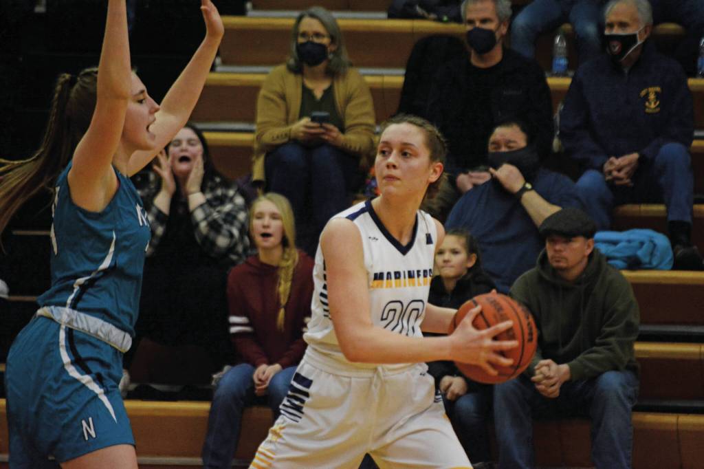 Lady Mariner Mel Morris tries to move around a Nikiski Bulldog during Senior Night on Friday, Feb. 25, 2022, at the Alice Witte Gym at Homer High School in Homer, Alaska. (Photo by Michael Armstrong/Homer News)