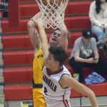 Ninilchiks Landon Colburn drives on Kenai Centrals Eli McCubbins on Saturday, March 5, 2022, at Kenai Central High School in Kenai, Alaska. (Photo by Jeff Helminiak/Peninsula Clarion)