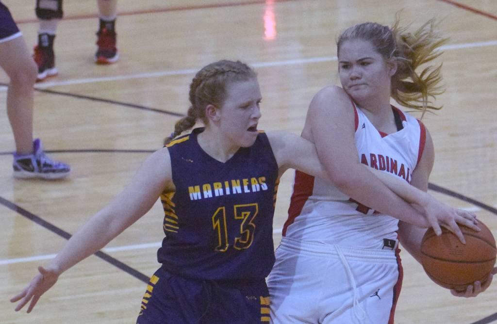 Kenai Centrals Emma Beck keeps the ball from Olivia Glasman on Saturday, March 12, 2022, at the Peninsula Conference tournament at Kenai Central High School in Kenai, Alaska. (Photo by Jeff Helminiak/Peninsula Clarion)