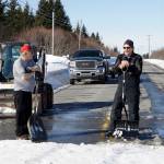 It takes a cosmic village
Kachemak Nordic Ski Club volunteers Roy Wilson, left, and Carl Brinkerhoff, right, keep a snow bridge over Diamond Ridge Road in shape for skiers competing in the Kachemak Marathon race on Saturday, March 19, 2022, in Homer, Alaska. (Photo by Michael Armstrong/Homer News)