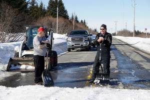 It takes a cosmic village
Kachemak Nordic Ski Club volunteers Roy Wilson, left, and Carl Brinkerhoff, right, keep a snow bridge over Diamond Ridge Road in shape for skiers competing in the Kachemak Marathon race on Saturday, March 19, 2022, in Homer, Alaska. (Photo by Michael Armstrong/Homer News)
