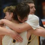 Justin Trail embraces Landon Colburn after the Ninilchik Wolverines won the Class 2A state basketball championship game at the Alaska Airlines Center in Anchorage, Alaska, on Saturday, March 19, 2022. (Camille Botello/Peninsula Clarion)