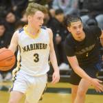 Homers Peyton Edens makes a move toward the basket during the Class 3A boys basketball fourth-place semifinals at the Alaska Airlines Center in Anchorage, Alaska, on Thursday, March 24, 2022. (Camille Botello/Peninsula Clarion)