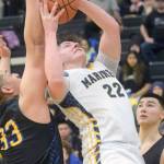 Homers Carter Tennison takes a shot against Barrows Uata Tuifua during the Class 3A boys basketball fourth-place semifinals at the Alaska Airlines Center in Anchorage, Alaska, on Thursday, March 24, 2022. (Camille Botello/Peninsula Clarion)