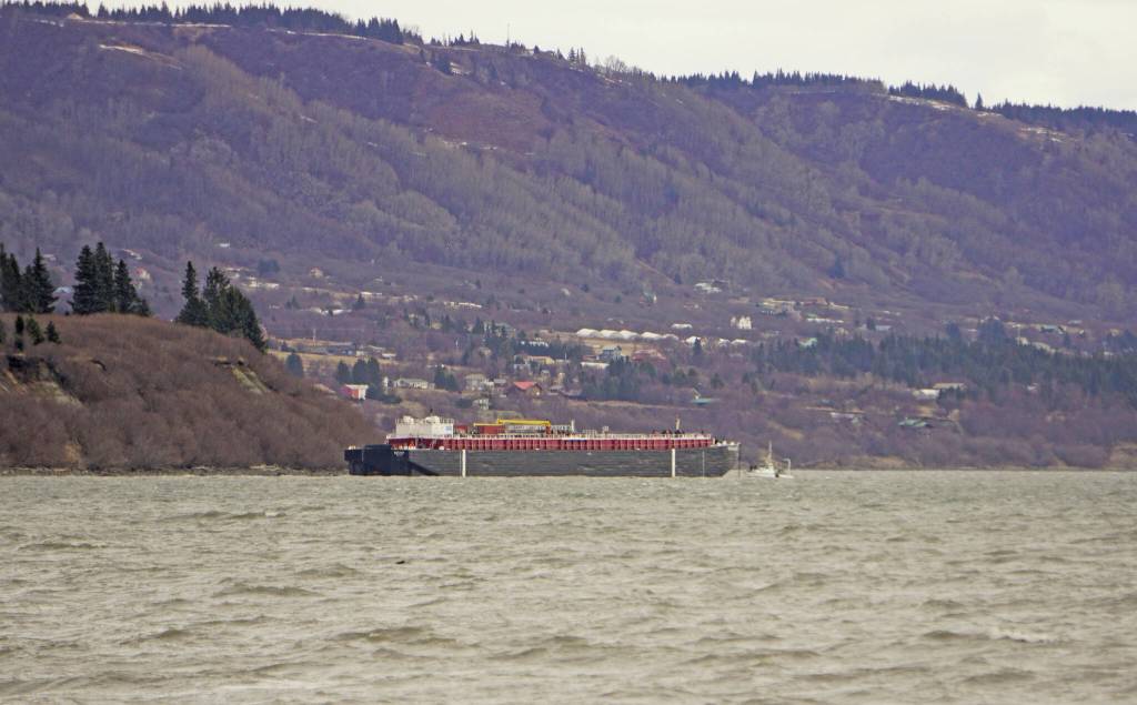 The Cook Inlet Spill Prevention and Response barge Redoubt is aground on the Mud Bay beach in Kachemak Bay off Kachemak Drive at about 1:30 p.m. Thursday, March 31, in Homer, . (Photo by Michael Armstrong/Homer News)