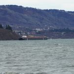 The Cook Inlet Spill Prevention and Response Inc. barge Redoubt is aground on the Mud Bay beach in Kachemak Bay off Kachemak Drive at about 1:30 p.m. Thursday, March 31, 2022, in Homer, Alaska. (Photo by Michael Armstrong/Homer News)