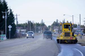 A street sweeper on Tuesday, April 19, 2022, cleans the bike and pedestrian lane on Ocean Drive in Homer, Alaska. Cleaning sand and debris off the side of the road will make Ocean Drive safer for Homer's growing bicycle community. (Photo by Michael Armstrong/Homer News)