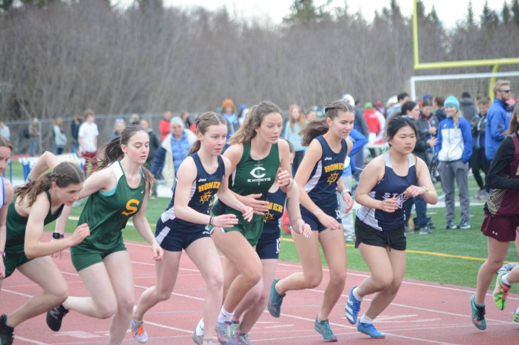 Runners in the girls 1,600-meter event start on Saturday, April 23, 2022 for the Homer Invite at Homer High School in Homer, Alaska. Mariner Eryn Field is third from left and Mariner Elena Badajos is second from right. (Photo by Michael Armstrong/Homer News)