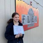 Sophomore Diane Lemieux-Pietrowski, the April recipient of the Homer Flex High School Phoenix Award, poses with her award. (Photo by Beth Schneider)