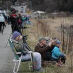 Birders check out shorebirds on the outgoing tide on Saturday, May 8, 2021, at Mud Bay on the Homer Spit in Homer, Alaska. (Photo by Michael Armstrong/Homer News)