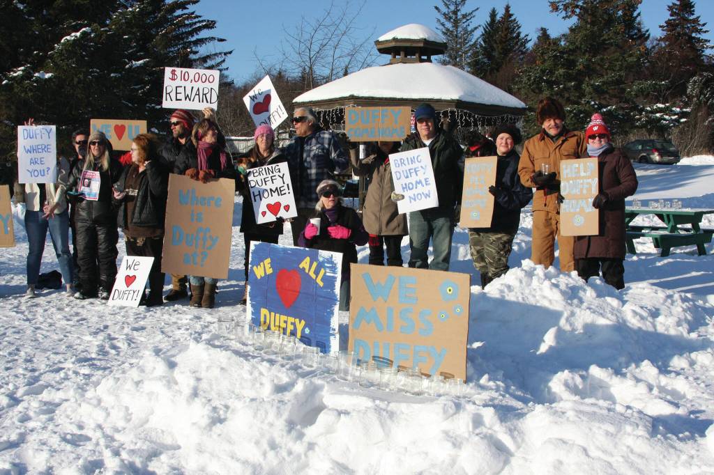 Friends of Anesha “Duffy” Murnane and members of the community supporting the campaign to bring her home pose with signs during a candlelight vigil held at WKFL Park in Homer, Alaska on Saturday, Feb. 1, 2020. (Photo by Delcenia Cosman)