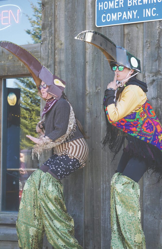 Dressed in bird costumes and walking on stilts, Brittany Briley, left, and Mallory Primm, right, make an appearance for the Homer Brewing Companys bird calling contest during the Kachemak Bay Shorebird Festival on Saturday, May 7, 2022, in Homer, Alaska. (Photo by Michael Armstrong/Homer News)