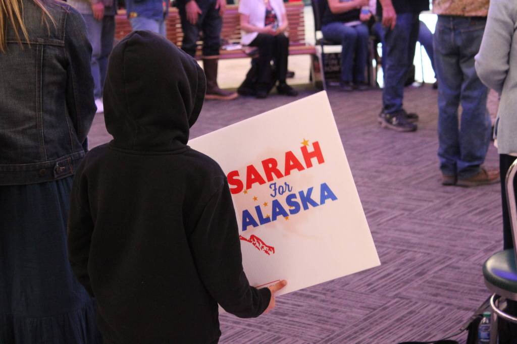 A child holds a Sarah for Alaska sign at a meet-and-greet event outside Gingers Restaurant on Saturday, May 14, 2022, in Soldotna, Alaska. (Ashlyn OHara/Peninsula Clarion)