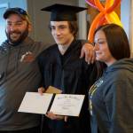 Flex School graduate Michael Ritter, center, poses with his parents, Andrew Roderick, left, and Katrina Roderick, right, after graduation ceremonies on Wednesday, May 18, 2022, at Lands End Resort in Homer, Alaska. (Photo by Michael Armstrong/Homer News)