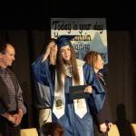 Delilah Harris turns her tassel at Homer High School commencement in the Alice Witte Gymnasium on Wednesday, May 18, 2022, at Homer High School in Homer, Alaska. At left is Kenai Peninsula School Board member Tim Daugharty. (Photo by Michael Armstrong/Homer News)