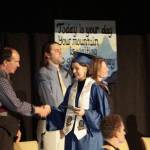 Mariah McGuire shakes the hand of Kenai Peninsual Board School Board member Tim Daugharty at Homer High School graduation exercises in the Alice Witte Gymnasium for commencement on Wednesday, May 18, 2022, at Homer High School in Homer, Alaska. (Photo by Michael Armstrong/Homer News)