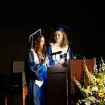 Valedictorians Serena Fankhauser, left, and Olivia Glasman, right, deliver their address at Homer High School graduation in the Alice Witte Gymnasium on Wednesday, May 18, 2022, at Homer High School in Homer, Alaska. (Photo by Michael Armstrong/Homer News)