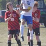 Soldotnas Zac Buckbee wins a header against Kenai Centrals Cole Langham and Joe Hamilton in the Peninsula Conference championship game Saturday, May 21, 2022, at Nikiski High School in Nikiski, Alaska. (Photo by Jeff Helminiak/Peninsula Clarion)