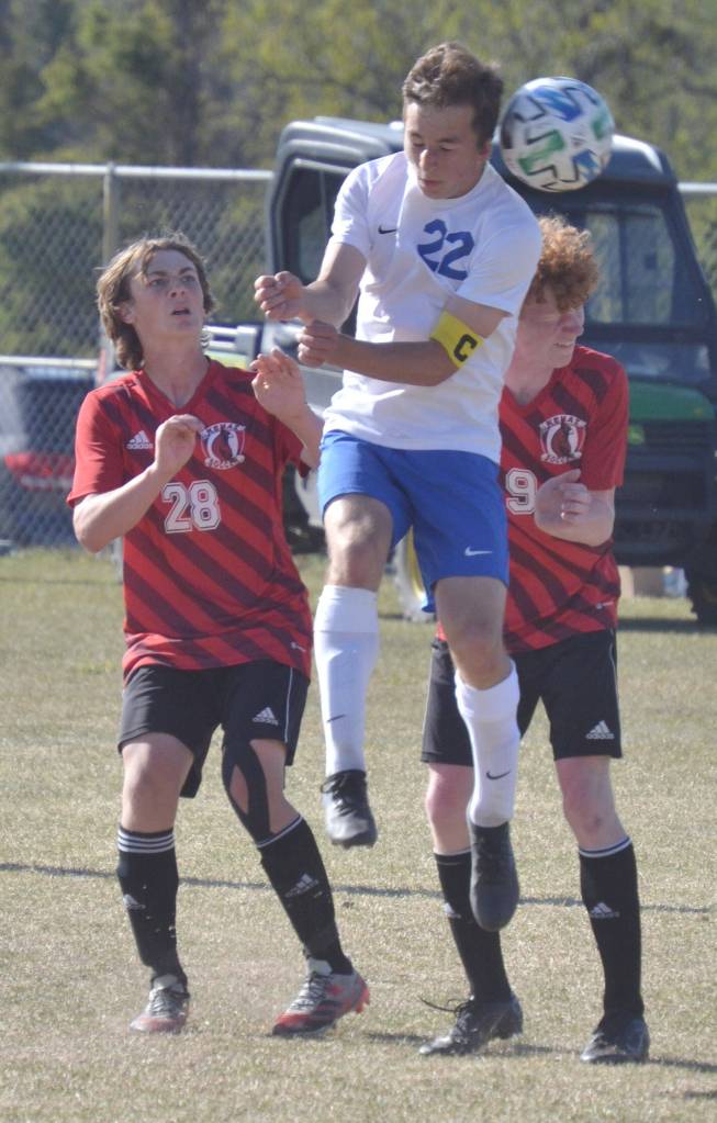 Soldotnas Zac Buckbee wins a header against Kenai Centrals Cole Langham and Joe Hamilton in the Peninsula Conference championship game Saturday, May 21, 2022, at Nikiski High School in Nikiski, Alaska. (Photo by Jeff Helminiak/Peninsula Clarion)