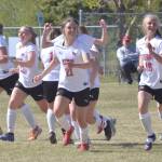 The Kenai Central girls celebrate Seanna Swansons game-winning goal in the Peninsula Conference championship game Saturday, May 21, 2022, at Nikiski High School in Nikiski, Alaska. (Photo by Jeff Helminiak/Peninsula Clarion)