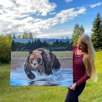 Tarryn Zerbinos shows one of her paintings to be displayed in June at Grace Ridge Breweing. (Photo provided)