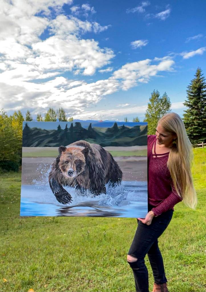 Tarryn Zerbinos shows one of her paintings to be displayed in June at Grace Ridge Breweing. (Photo provided)