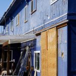 The south side of 397 E. Pioneer Avenue as seen on Friday, May 27, 2022. The barn door to the right was cut into the wall of the former Refuge Chapel, a modifcation other tenants of the building claimed had been done in violation of the business condominium association rules. (Photo by Michael Armstrong/Homer News)