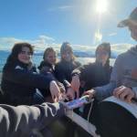 Members of Homer Flex School's Marine Biology class on April 21, 2022, prepare to deploy a CTD, or conductivity, temperature, and depth, device in Kachemak Bay, Alaska. (Photo provided, Center for Alaskan Coastal Studies)