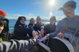 Members of Homer Flex School's Marine Biology class on April 21, 2022, prepare to deploy a CTD, or conductivity, temperature, and depth, device in Kachemak Bay, Alaska. (Photo provided, Center for Alaskan Coastal Studies)