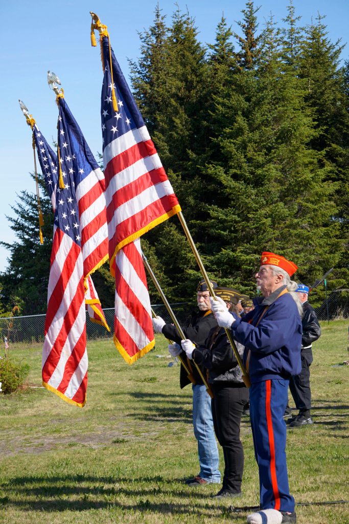 An honor guard consisting of members of the Marine Corps League, American Legion Post 16, Homer, and Veterans of Foreign Wars Post 10221, Anchor Point, hoist flags at Memorial Day Ceremonies on Monday, May 30, 2022, at Hickerson Memorial Cemetery near Homer, Alaska. (Photo by Michael Armstrong/Homer News)