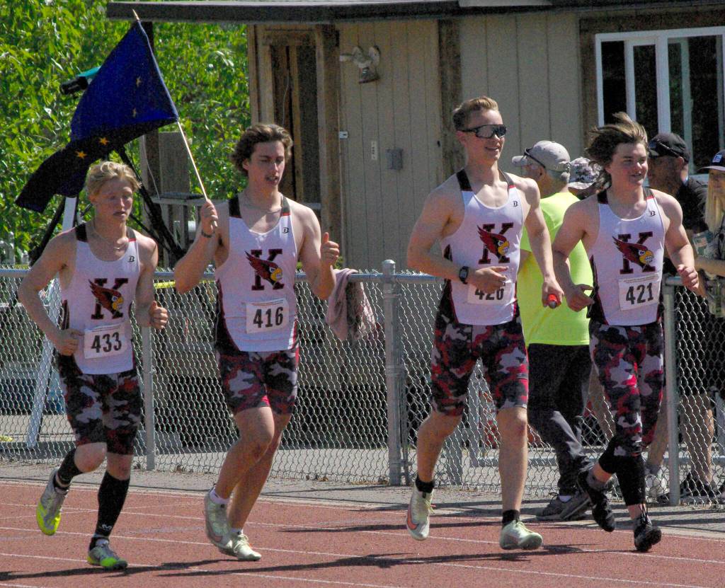 Kenai Centrals James Sparks, Jacob Begich, Tyler Hippchen and Reagan Graves celebrate after winning the 400-meter relay Saturday, May 28, 2022, at the Division II state track and field meet at Dimond High School in Anchorage, Alaska. (Photo by Jeff Helminiak/Peninsula Clarion)