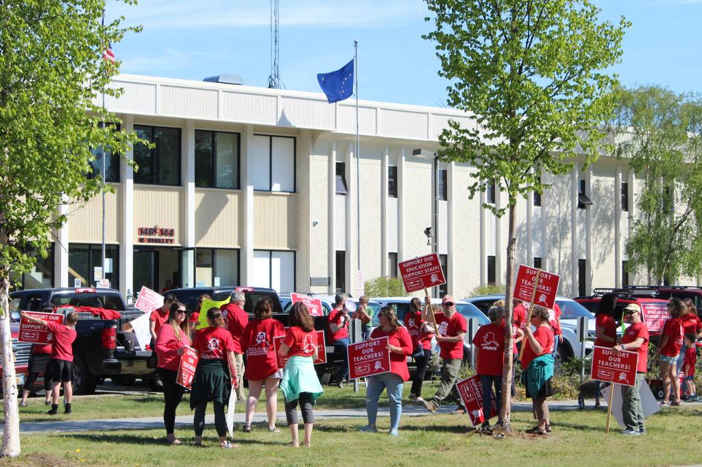 Demonstrators rally in support of Kenai Peninsula Borough School District teachers and staff outside of the George A. Navarre Admin Building on Thursday, May 26, 2022 in Soldotna, Alaska. (Ashlyn OHara/Peninsula Clarion)