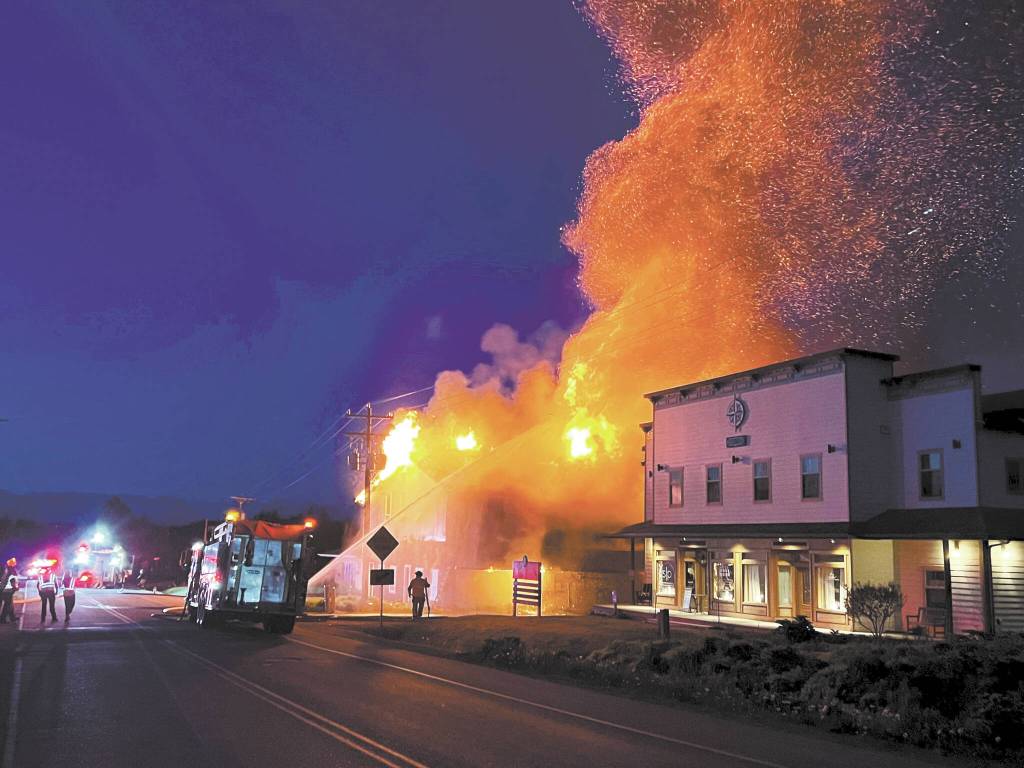 Homer Volunteer Fire Department firefighters attack the East Bunnell Avenue fire at about 3 a.m. Saturday, June 4, 2022, in Homer, Alaska. The Compass Rose building at right had minor damage from heat exposure but otherwise did not burn. (Photo courtesy of Homer Voluntee Fire Department)