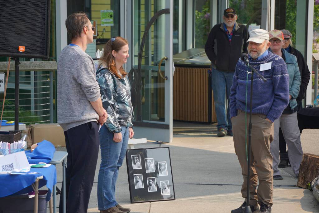 Ed Berg, right, Anesha Duffy Murnanes stepfather, presents the Loved & Lost Memorial Bench to Homer Public Library Head Dreictor David Berry, left, and Julie Engebretsen, center, Deputy City Planner and Special Projects Coordinator, at the dedication of the bench and a memorial for Murnane on Sunday, June 12, 2022, at the Homer Public Library in Homer, Alaska. (Photo by Michael Armstrong/Homer News)