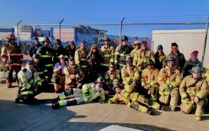 Graduates of a multi-agency EMT class pose at the training site on the Homer Spit. (Photo provided)