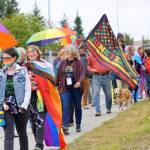 Marchers wearing Pride rainbow colors and carrying Juneteenth flags march in the Pride-X-Juneteenth parade on Saturday, June 18, 2022, on Pioneer Avenue in Homer, Alaska. (Photo by Michael Armstrong/Homer News)