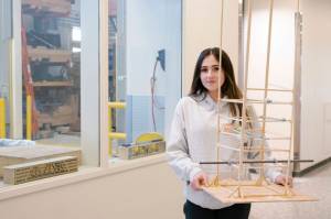 ANSEP Acceleration Academy (Summer) student Alivia Fefelov poses on Tuesday, June 21, 2022, at the University of Alaska Anchorage with a balsa tower she helped build to learn about engineering structures to survive earthquakes. The tower withstood a simulated earthquake. (Photo provided)