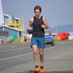 Tim Robinson, the first-place man in the 2022 Homer Spit Run Half Marathon, crosses the finish line on Saturday, June 25, 2022, at the End of the Road Park in Homer, Alaska. (Photo by Michael Armstrong/Homer News)