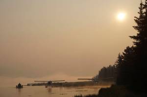 Smoke from wildfires in Southwestern Alaska casts a pall over Beluga Lake on Wednesday morning, June 29, 2022, in Homer, Alaska. (Photo by Michael Armstrong/Homer News)