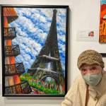 Carolyn Seymour poses next to one of her paintings. She shows her work Friday and Saturday, July 8-9, 2022, at Ptarmigan Arts in Homer, Alaska. The show honors Seymour, Ptarmigans oldest artist, who turned 100 in May. (Photo provided)