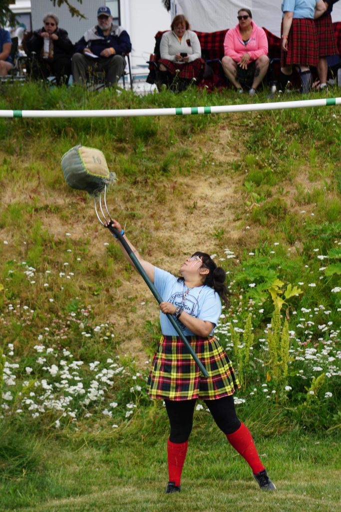 Evelyn Delgado participates in the sheaf toss at the Kachemak Bay Highland Games on Saturday, July 2, 2022, at Karen Hornaday Park in Homer, Alaska. (Photo by Michael Armstrong)
