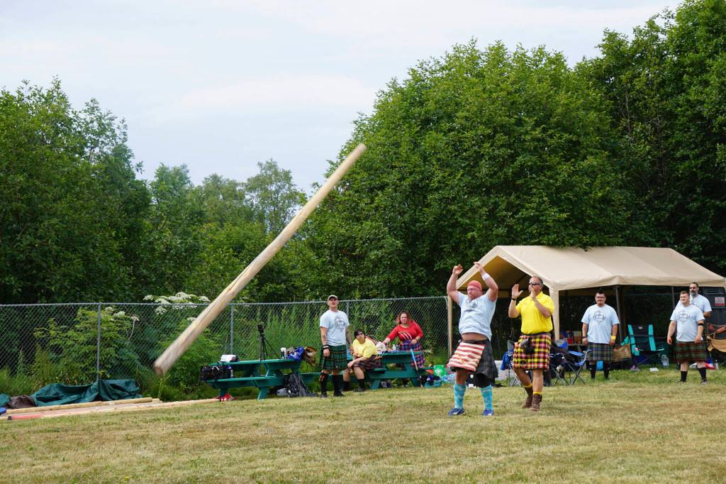 Chris Carr throws the caber at the Kachemak Bay Highland Games on Saturday, July 2, 2022, at Karen Hornaday Park in Homer, Alaska. (Photo by Michael Armstrong)