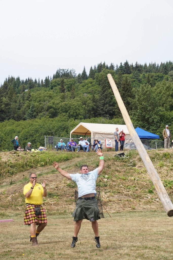 Danny Autrey throws the caber at the Kachemak Bay Highland Games on Saturday, July 2, 2022, at Karen Hornaday Park in Homer, Alaska. (Photo by Michael Armstrong)