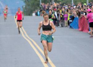Sewards Hannah Lafleur leads a trail of runners to the finish to take second in the womens Mount Marathon Race on Monday, July 4, 2022, in Seward, Alaska. (Photo by Jeff Helminiak/Peninsula Clarion)