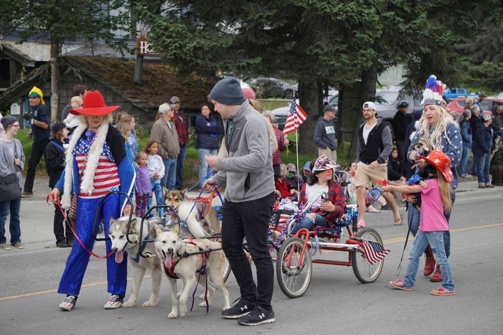 Sled dogs pull a cart with the Alaskan Riding Trails group during the Homer Fourth of July parade on Monday, July 4, 2022, on Pioneer Avenue in Homer, Alaska. (Photo by Michael Armstrong/Homer News)