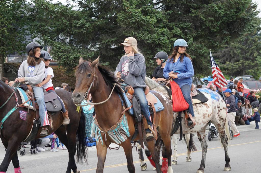 Horses and riders with the Trail Blazers group participate in the Homer Fourth of July parade on Monday, July 4, 2022, on Pioneer Avenue in Homer, Alaska. (Photo by Michael Armstrong/Homer News)