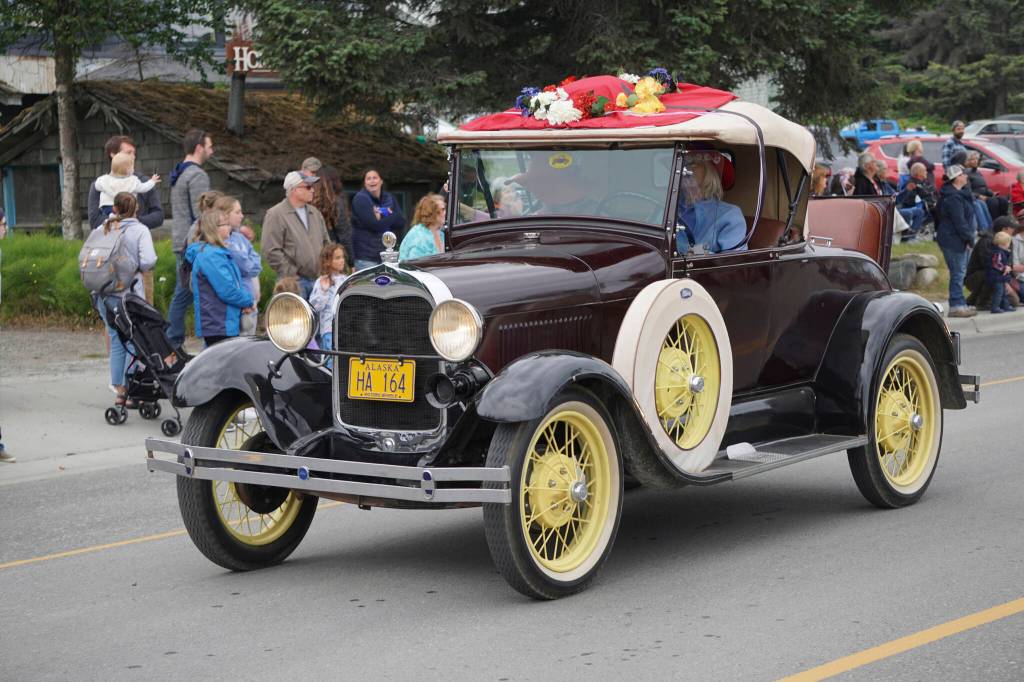 An antique Ford with Snow Bird Red Hatters was one of several classic cars driven in the Homer Fourth of July parade on Monday, July 4, 2022, on Pioneer Avenue in Homer, Alaska. (Photo by Michael Armstrong/Homer News)